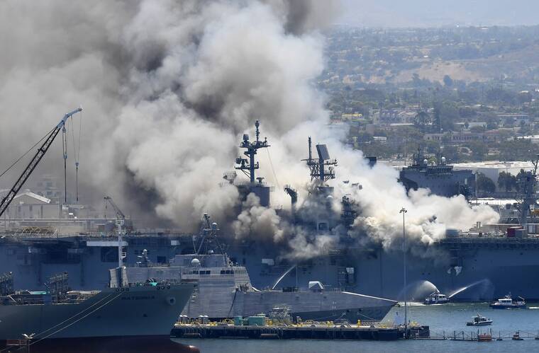 ASSOCIATED PRESS
                                Smoke rose from the USS Bonhomme Richard, in July 2020, at Naval Base San Diego in San Diego, after an explosion and fire on board the ship at Naval Base San Diego. A sailor accused of starting the fire that destroyed the USS Bonhomme Richard will face a court-martial for arson.