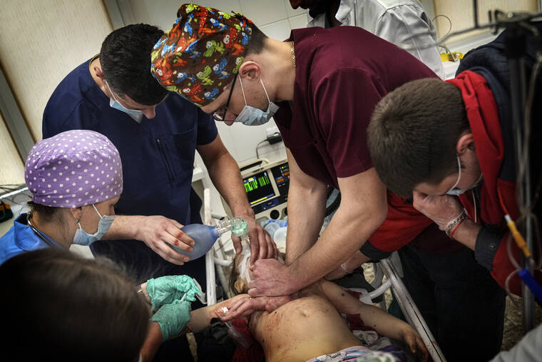 ASSOCIATED PRESS
                                Medics perform CPR on a girl at the city hospital of Mariupol, who was injured during shelling in a residential area in eastern Ukraine today. The girl did not survive.