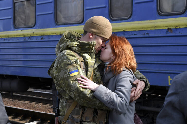 ASSOCIATED PRESS
                                A couple embrace prior to the woman boarding a train carriage leaving for western Ukraine, at the railway station in Kramatorsk, eastern Ukraine, Sunday.
