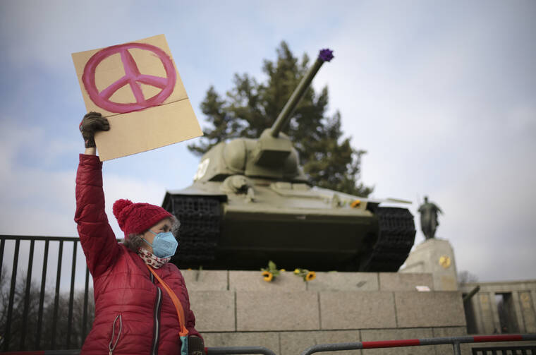 ASSOCIATED PRESS
                                A woman shows a peace sign in front of a Russian WWII tank at the Soviet War Memorial at the bolevard ‘Strasse des 17. Juni’ alongside a rally against Russia’s invasion of Ukraine in Berlin, Germany, today.