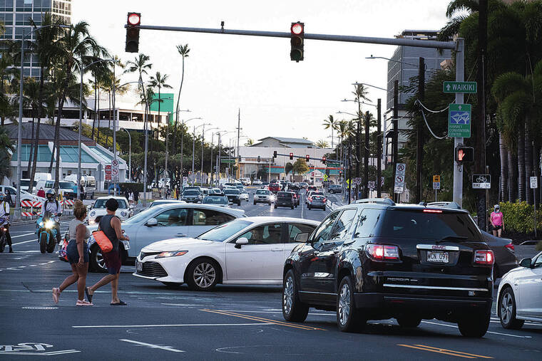 GEORGE F. LEE / APRIL 2021 
                                Pedestrians cross Ward Avenue at King Street. This intersection is one of the 10 sites being considered for a red-light traffic camera enforcement pilot project.