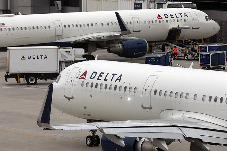 ASSOCIATED PRESS / JULY 12 Delta Air Lines plane leaves the gate at Logan International Airport in Boston.
