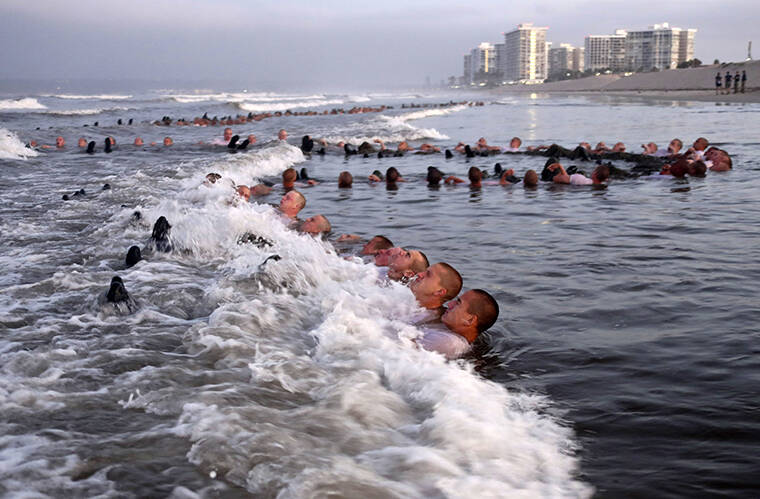 U.S. NAVY / AP
                                SEAL candidates participating in “surf immersion” during Basic Underwater Demolition/SEAL (BUD/S) training at the Naval Special Warfare (NSW) Center in Coronado, Calif.