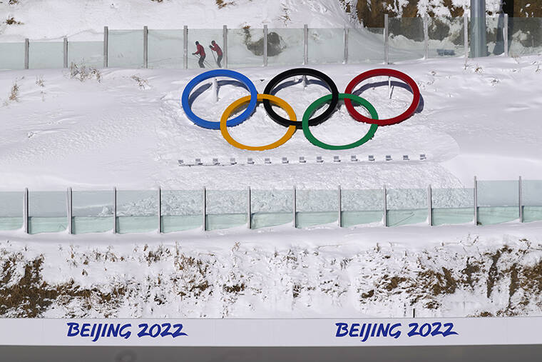 ASSOCIATED PRESS / FEB. 3
                                Biathletes skate above the Olympic rings during practice at the 2022 Winter Olympics in Zhangjiakou, China.