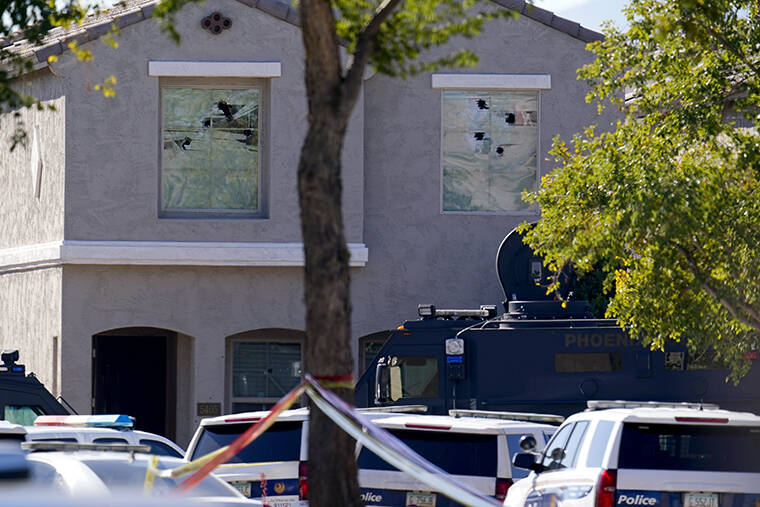 ASSOCIATED PRESS / FEB. 11
                                Multiple holes in windows can be seen at a house where five Phoenix Police Department officers were shot and four others were injured after responding to a shooting inside the home in Phoenix.