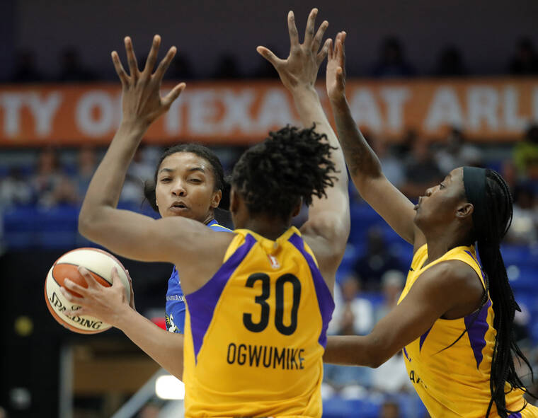 ASSOCIATED PRESS
                                Dallas Wings center Imani McGee-Stafford looks to make a pass as Los Angeles Sparks’ Nneka Ogwumike and Alexis Jones, right, defend during a WNBA basketball game in 2019.