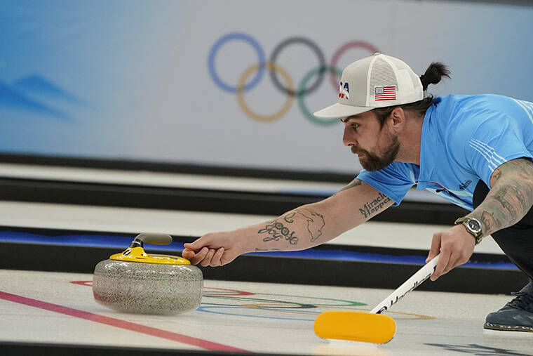 ASSOCIATED PRESS
                                Christopher Plys, of the United States, throws a rock during the mixed doubles curling match against Australia at the Beijing Winter Olympics today.