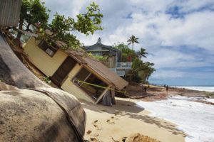 CINDY ELLEN RUSSELL / CRUSSELL@STARADVERTISER.COM
                                A house at 59-181-H Ke Nui Road on Oahu’s North Shore rested on the sand after sliding onto the beach early Monday.