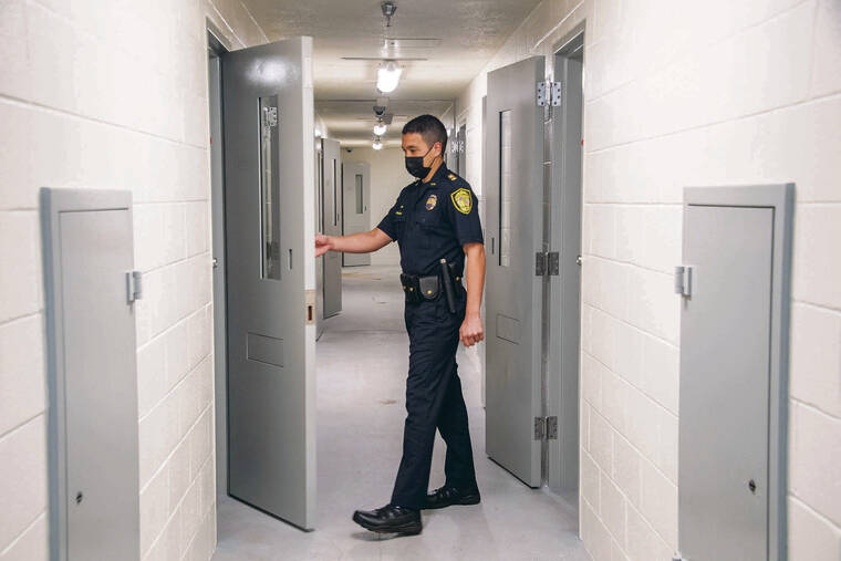 CRAIG T. KOJIMA / CKOJIMA@ STARADVERTISER.COM
                                Capt. Parker Bode opens a cell door in HPD’s Central Receiving Division, which reopened Friday.