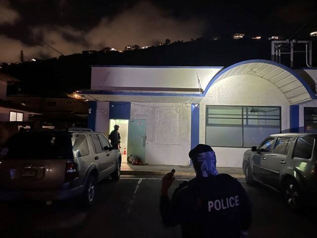 COURTESY HONOLULU POLICE DEPARTMENT This Honolulu Police Department courtesy photo shows police officers outside an apparently illegal gambling den operating out of a storefront in Palolo.