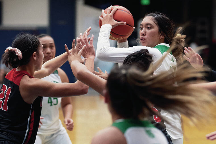GEORGE F. LEE / GLEE@STARADVERTISER.COM
                                Konawaena’s Braelyn Kauhi looked to pass the ball against Lahainaluna at Moanalua Gym on Friday.