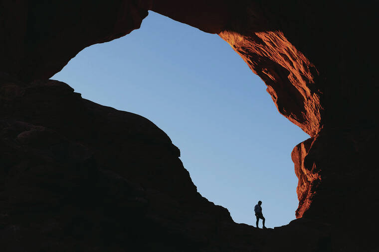 NEW YORK TIMES
                                A hiker at the Double Arch formation in Arches National Park in Utah in February.