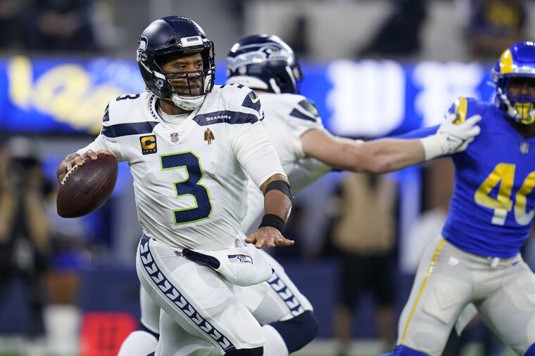 ASSOCIATED PRESS
                                Seattle Seahawks quarterback Russell Wilson looked to throw during the first half of the team’s game against the Los Angeles Rams, Dec. 21, in Inglewood, Calif. The Seahawks have reportedly agreed to deal quarterback Russell Wilson to Denver for a mammoth haul of five draft picks and three players that includes two first-round picks and quarterback Drew Lock.