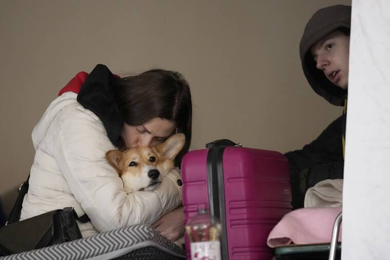 ASSOCIATED PRESS
                                A refugee from Ukraine hugs her dog at a temporary shelter in Ubla, Slovakia, today.