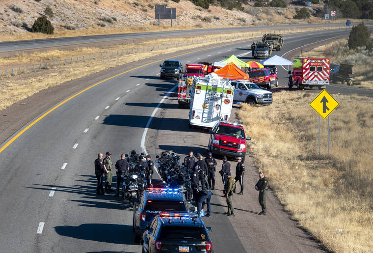 THE ALBUQUERQUE JOURNAL / AP
                                Law enforcement gathers along Interstate 25 as several agencies take part in a search for a suspect who was involved in a kidnaping and high speed chase that resulted in a Santa Fe Police Officer being killed.