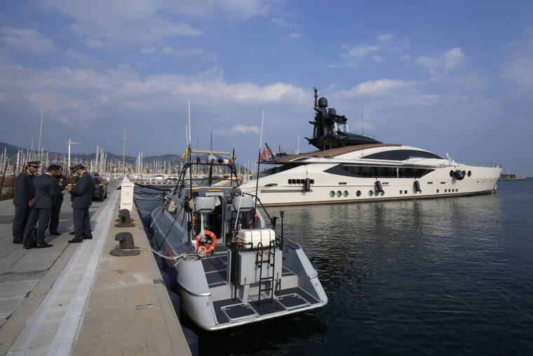 ANTONIO CALANNI / AP
                                Italian Finance Police stand by the yacht “Lady M”, owned by Russian oligarch Alexei Mordashov, docked at Imperia’s harbor, Italy.