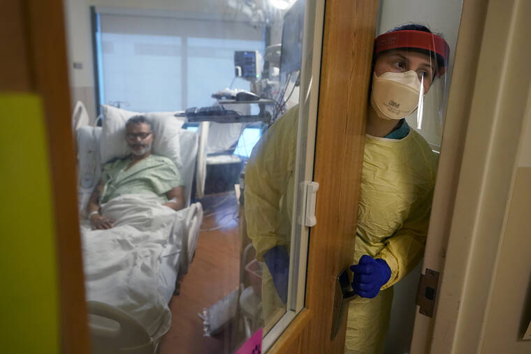 ASSOCIATED PRESS /JAN. 3
                                Registered nurse Rachel Chamberlin steps out of an isolation room where a patient recovers from COVID-19 at the Dartmouth-Hitchcock Medical Center, in Lebanon, N.H., in January. The official global death toll from COVID-19 is on the verge of eclipsing 6 million.