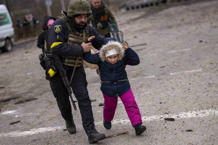 ASSOCIATED PRESS
                                A Ukrainian police officer ran while holding a child as the artillery echoed nearby, while fleeing Irpin on the outskirts of Kyiv, Ukraine, today. Russia announced yet another cease-fire and a handful of humanitarian corridors to allow civilians to flee Ukraine.