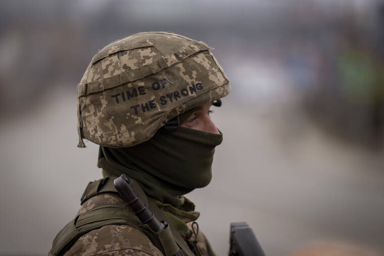 ASSOCIATED PRESS
                                A Ukrainian soldier stood guard at a checkpoint on the outskirts of Kyiv, Ukraine, today. Russia announced yet another cease-fire and a handful of humanitarian corridors to allow civilians to flee Ukraine.