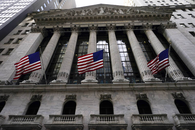 ASSOCIATED PRESS
                                U.S. flags flew outside the New York Stock exchange, Jan. 14, in the Financial District in New York. Stocks are falling in morning trading on Wall Street, as more gains for oil prices threaten to worsen the world’s already high inflation.