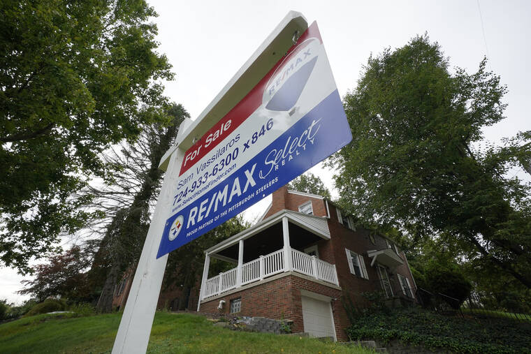 ASSOCIATED PRESS / SEPT. 21
                                Average long-term U.S. mortgage rates fell slightly this week, after rising to their highest level in three years last week. This is a home for sale in Mount Lebanon, Pa., last year.