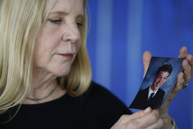 ASSOCIATED PRESS
                                Dede Yoder poses for a picture with a photo of her son, Chris Yoder, after making a statement during a hearing in New York today. People who lost loved ones or years of their own lives to opioid addiction are getting their first and perhaps only chance to confront members of the Sackler family who own OxyContin maker Purdue Pharma. Today’s virtual court hearing is being run by a U.S. Bankruptcy Court judge.