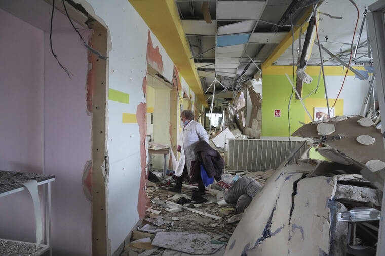 ASSOCIATED PRESS / MARCH 9
                                A medical worker walks through the hall of a maternity hospital damaged in a shelling attack in Mariupol, Ukraine. Associated Press journalists, who have been reporting from inside blockaded Mariupol since early in the war, documented this attack on the hospital and saw the victims and damage firsthand. They shot video and photos of several bloodstained, pregnant mothers fleeing the blown-out maternity ward, medics shouting, children crying.
