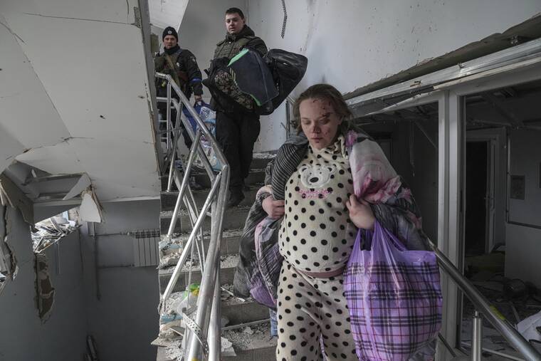 ASSOCIATED PRESS / MARCH 9
                                Mariana Vishegirskaya walks downstairs at a maternity hospital damaged by shelling in Mariupol, Ukraine. Vishegirskaya survived the shelling and later delivered a baby girl in another hospital.