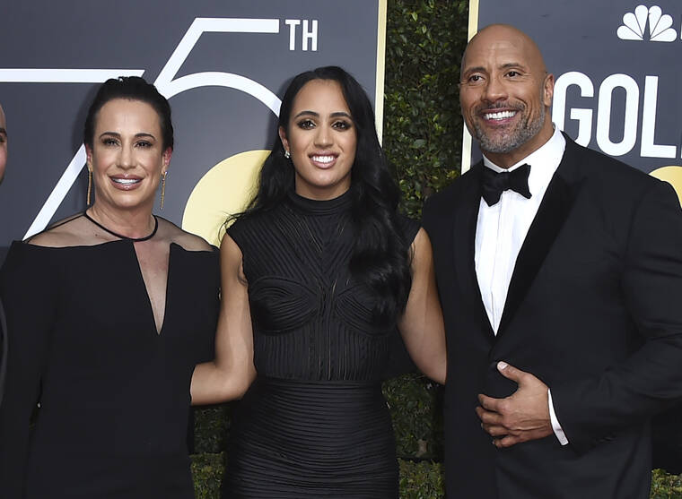 JORDAN STRAUSS/INVISION/ASSOCIATED PRESS
                                Dwayne Johnson, right, appeared with his business partner and ex-wife Dany Garcia, left, and their daughter Simone at the 75th annual Golden Globe Awards in Beverly Hills, Calif. in January 2018. Johnson credits the women in his life including Garcia, his wife Lauren, mother Ata, and three daughters for making him who he is.
