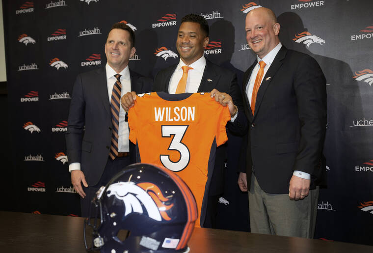 ASSOCIATED PRESS
                                Denver Broncos new starting quarterback Russell Wilson, center, is flanked by head coach Nathaniel Hackett, right, and general manager George Paton after a news conference today at the team’s headquarters in Englewood, Colo.