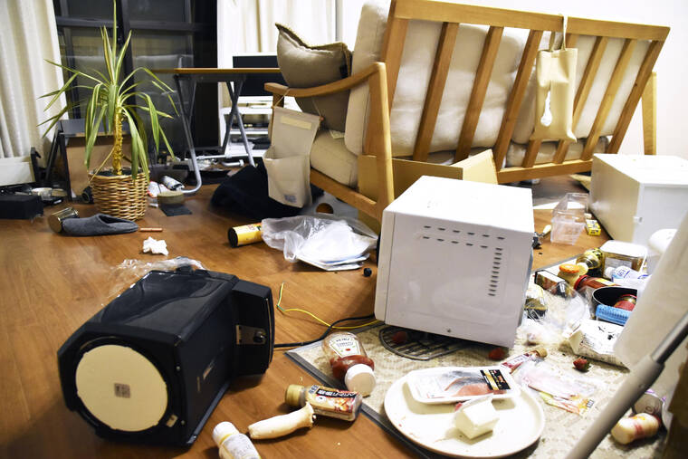 KYODO NEWS VIA AP
                                Furniture and electrical appliance are scattered at an apartment in Fukushima, Japan.
