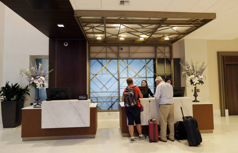ASSOCIATED PRESS
                                Guests stood at the front desk, in September 2018, at the Embassy Suites by Hilton hotel in Seattle’s Pioneer Square neighborhood in Seattle.