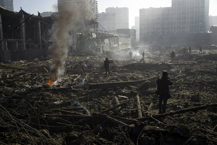 ASSOCIATED PRESS
                                People gathered amid the destruction caused by the shelling of a shopping center, in Kyiv, Ukraine, today.