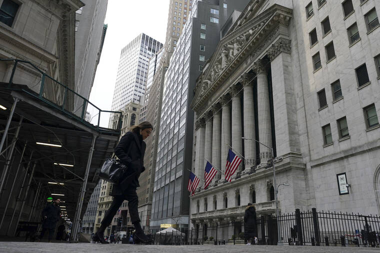 ASSOCIATED PRESS
                                Pedestrians walked past the New York Stock Exchange, Feb. 24. Stocks capped a day of choppy trading on Wall Street with a modestly lower finish today, giving back some of their recent gains after the major indexes notched their best week in more than a year.