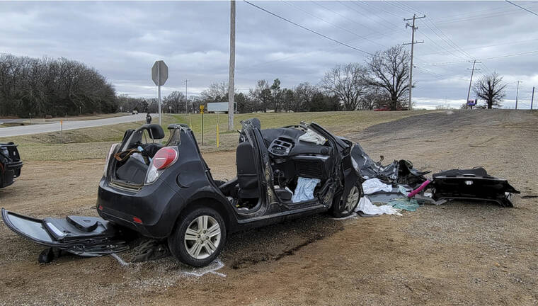 NEWSNATION KFOR / AP
                                A heavily damaged vehicle is seen off a road in Tishomingo, Okla., following a two-vehicle collision in which six teenage students were killed.