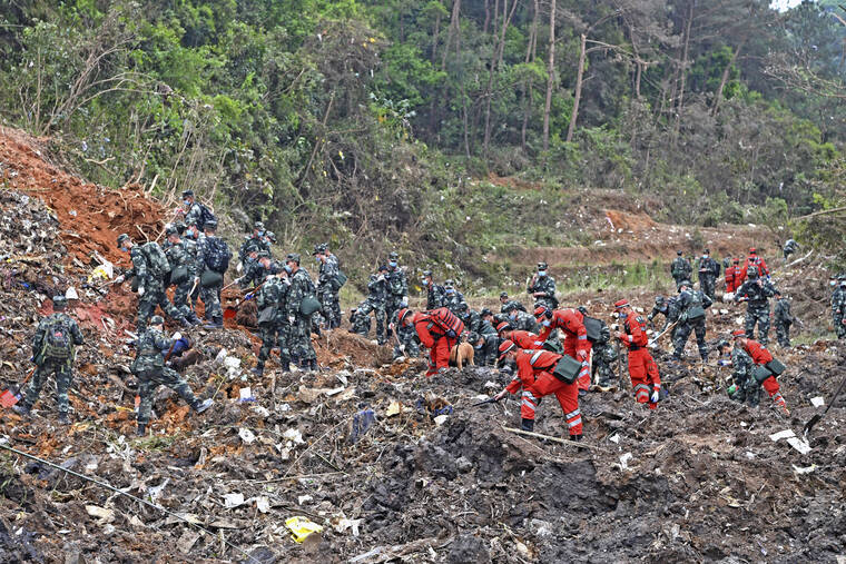 XINHUA / AP
                                Rescue workers search for the black boxes at a plane crash site in Tengxian county, southwestern China’s Guangxi Zhuang Autonomous Region.