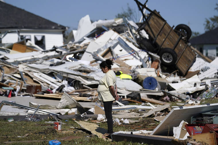 ASSOCIATED PRESS
                                Bertelina Martinez, who lives nearby and her son lives across the street, looks over destruction after a tornado struck the area in Arabi, La., today.