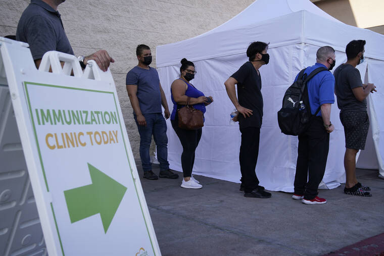 ASSOCIATED PRESS
                                People wait in line for COVID-19 vaccinations at an event at La Bonita market, a Hispanic grocery store on July 7 in Las Vegas.