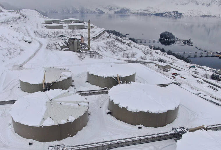 ALYESKA PIPELINE SERVICE COMPANY VIA AP / MARCH 16
                                Drone photo provided by Alyeska Pipeline Co. shows snow covering 62-foot tall and acre-wide oil tanks at the Valdez Marine Terminal in Valdez, Alaska. Workers at the endpoint of the trans-Alaska oil pipeline are using saws to cut up large blocks of hard-packed snow on top of the oil storage tanks so they can shove the chunks off the tanks, some of which have damaged infrastructure after more than 4 feet of snow fell in Valdez in a month.