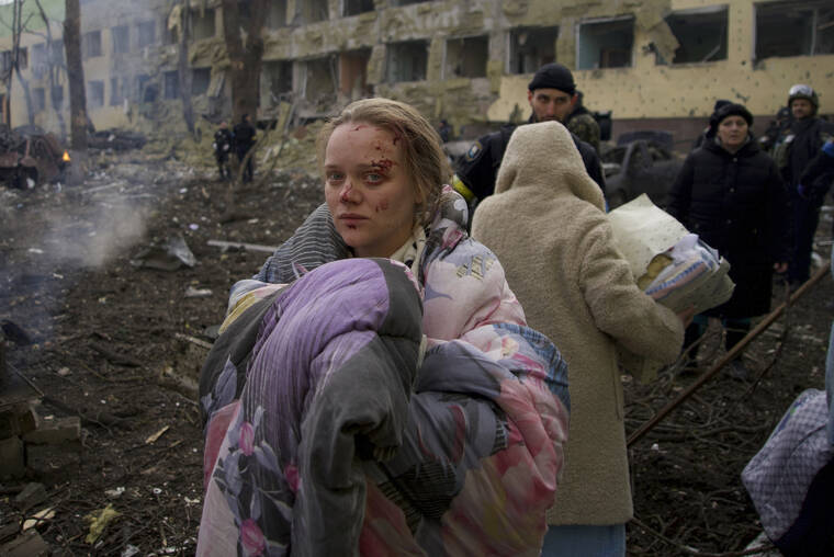 ASSOCIATED PRESS / MARCH 9
                                Mariana Vishegirskaya stands outside a maternity hospital that was damaged by shelling in Mariupol, Ukraine. Visheirskaya was taken to another nearby hospital where she gave birth the following day to a baby girl she named Veronika.