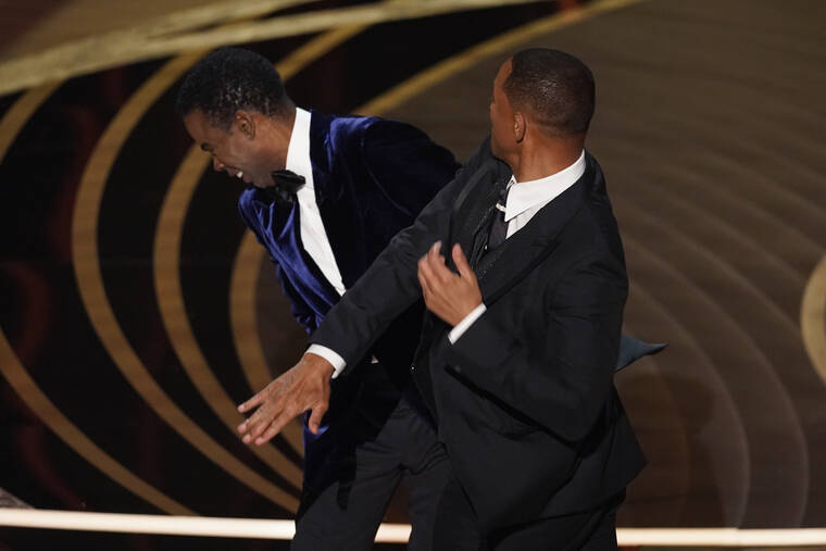ASSOCIATED PRESS
                                Will Smith, right, hits presenter Chris Rock on stage while presenting the award for best documentary feature at the Oscars today at the Dolby Theatre in Los Angeles.