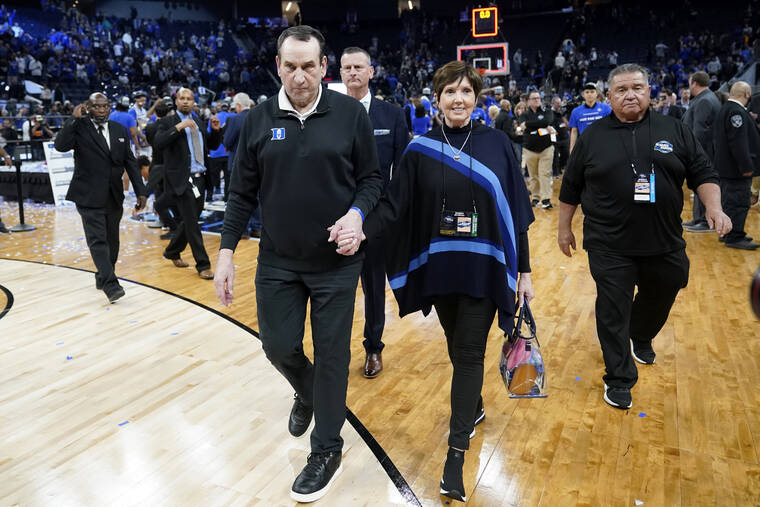 ASSOCIATED PRESS
                                Duke head coach Mike Krzyzewski, left, walks off the court with his wife, Mickie, after Duke defeated Arkansas in a college basketball game in the Elite 8 round of the NCAA men’s tournament in San Francisco on Saturday.