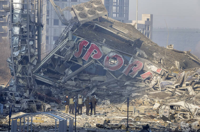 ASSOCIATED PRESS / MARCH 21
                                People examine the damage after shelling of a shopping center, in Kyiv, Ukraine. Eight people were killed in the attack.