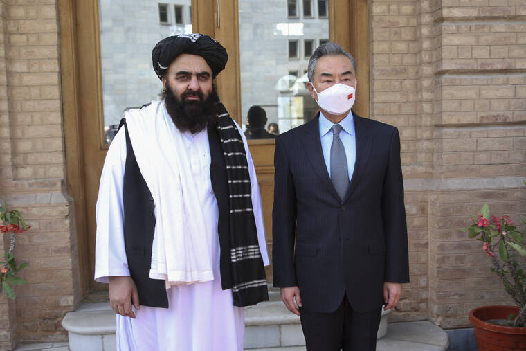 XINHUA VIA AP
                                Chinese Foreign Minister Wang Yi, right, poses for photos with Amir Khan Muttaqi, acting foreign minister of the Afghan Taliban’s caretaker government, in Kabul, Afghanistan on March 24.