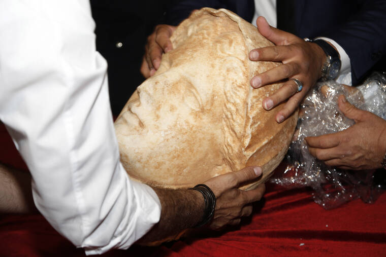 YOUSEF MURAD / AP
                                A Hellenic sculpture of a head from the ancient Libya city of Cyrene is displayed after it was returned by the United States Thursday, in Tripoli, Libya.