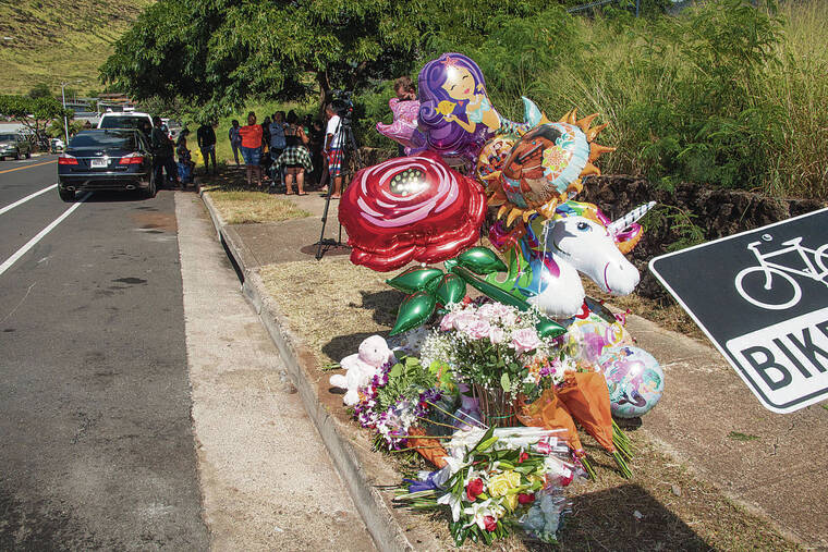 CRAIG T. KOJIMA / CKOJIMA@STARADVERTISER.COM
                                A roadside memorial was created Sunday for the two people, including a 7-year-old girl, who died in a two-car crash in Nanakuli on Saturday.
