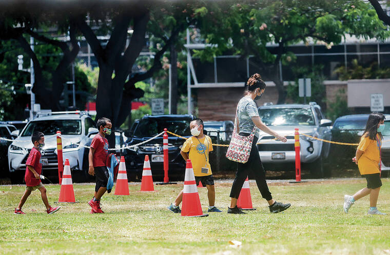 JAMM AQUINO/ AUG. 13
                                The state Department of Education made outdoor masking optional at schools starting March 9. Students wore masks to walk back to class after outdoor activity at Queen Kaahumanu Elementary School before the rule was eased.