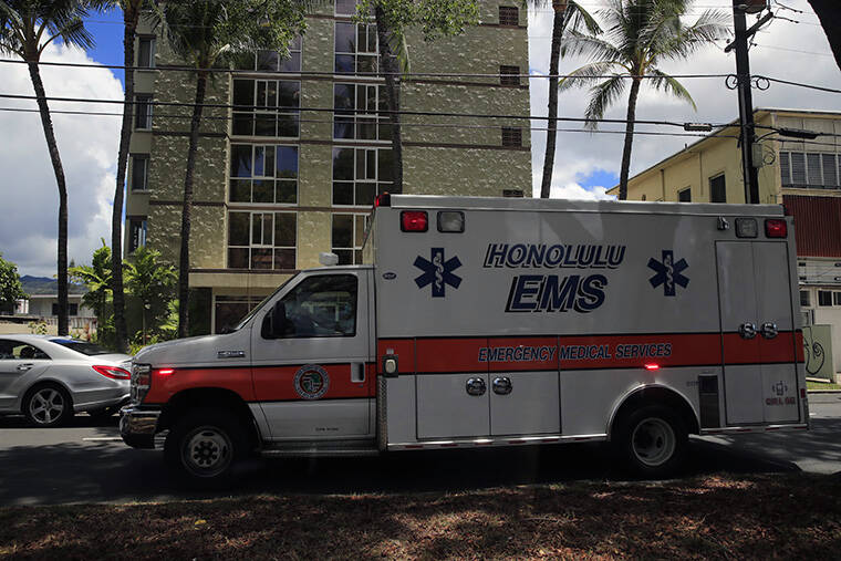 STAR-ADVERTISER / AUG. 31 A city ambulance travels with its sirens and lights activated along Kalakaua Avenue.