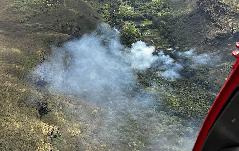 COURTESY KFD Kauai firefighters extinguished a brush fire in Makaweli Valley on Friday.