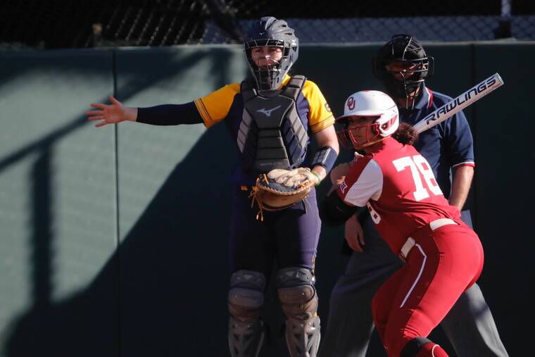 JAMM AQUINO / JAQUINO@STARADVERTISER.COM
                                California catcher Makena Smith signals to the pitcher to intentionally walk Oklahoma’s Jocelyn Alo in the bottom of the third inning with nobody on base trailing 8-0 this afternoon.